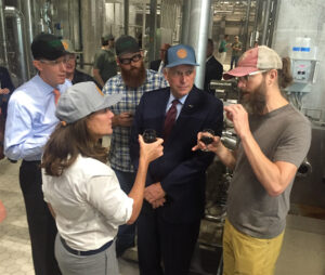 Greg Koch (right), co-founder and CEO of Stone Brewing Co., shares a sample of the imperial stout wort with (from left) Todd Haymore, Virginia secretary of agriculture and forestry; First Lady Dorothy McAuliffe; Peter Weins of Stone; and Virginia Governor Terry McAuliffe. Photo by Lee Graves
