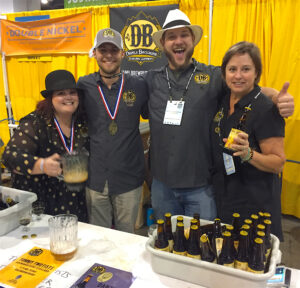 The Devils Backbone crew at the Great American Beer Festival includes Dizzle Clark (from left), taproom manager; Wade Hughes, pathfinder; Matt Castoro, senior brewer; and Heidi Crandall, co-founder. Photo by Lee Graves